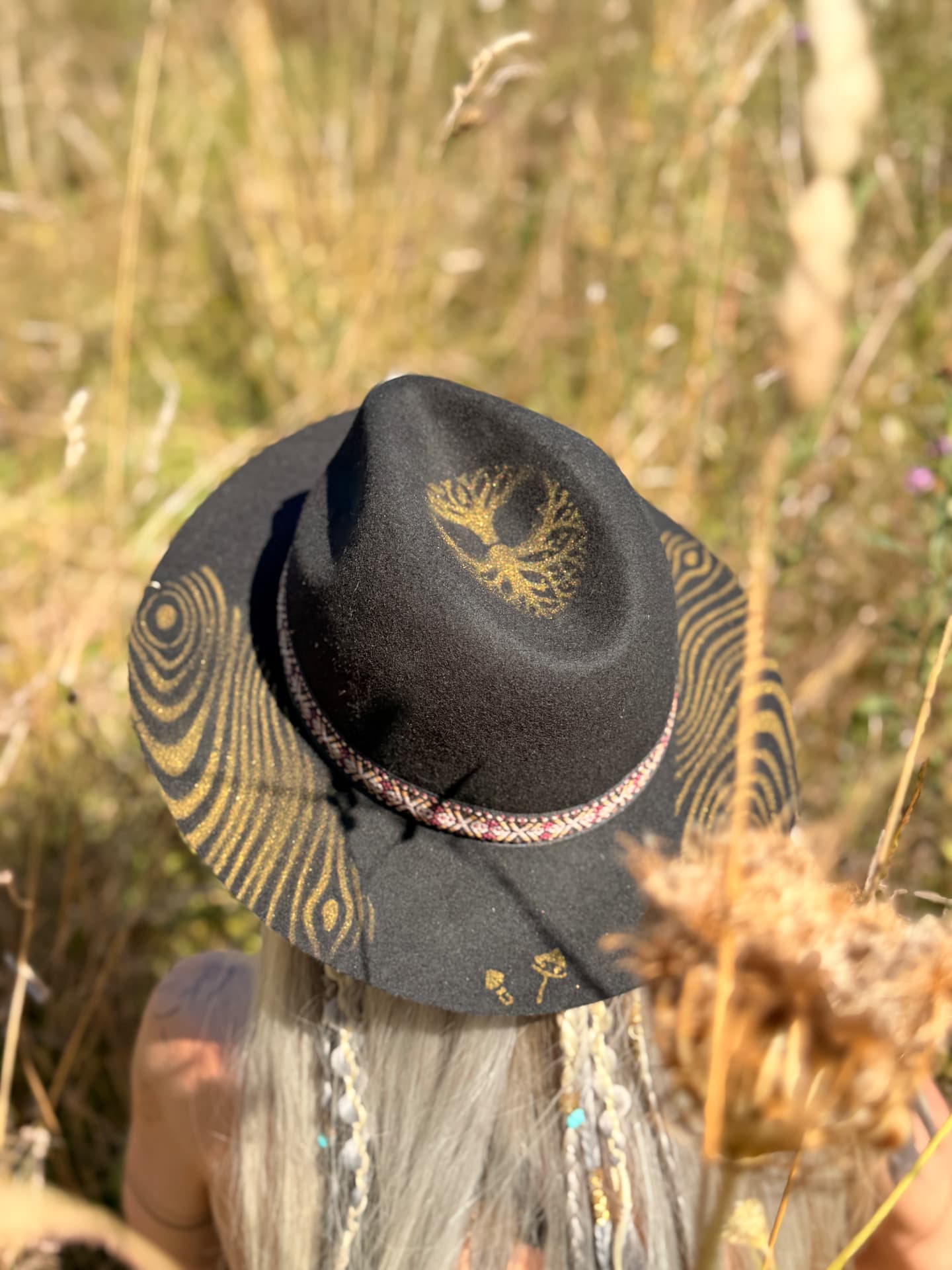Rooted, a black felt hat with a golden tree of life and hand-painted woodgrain brim