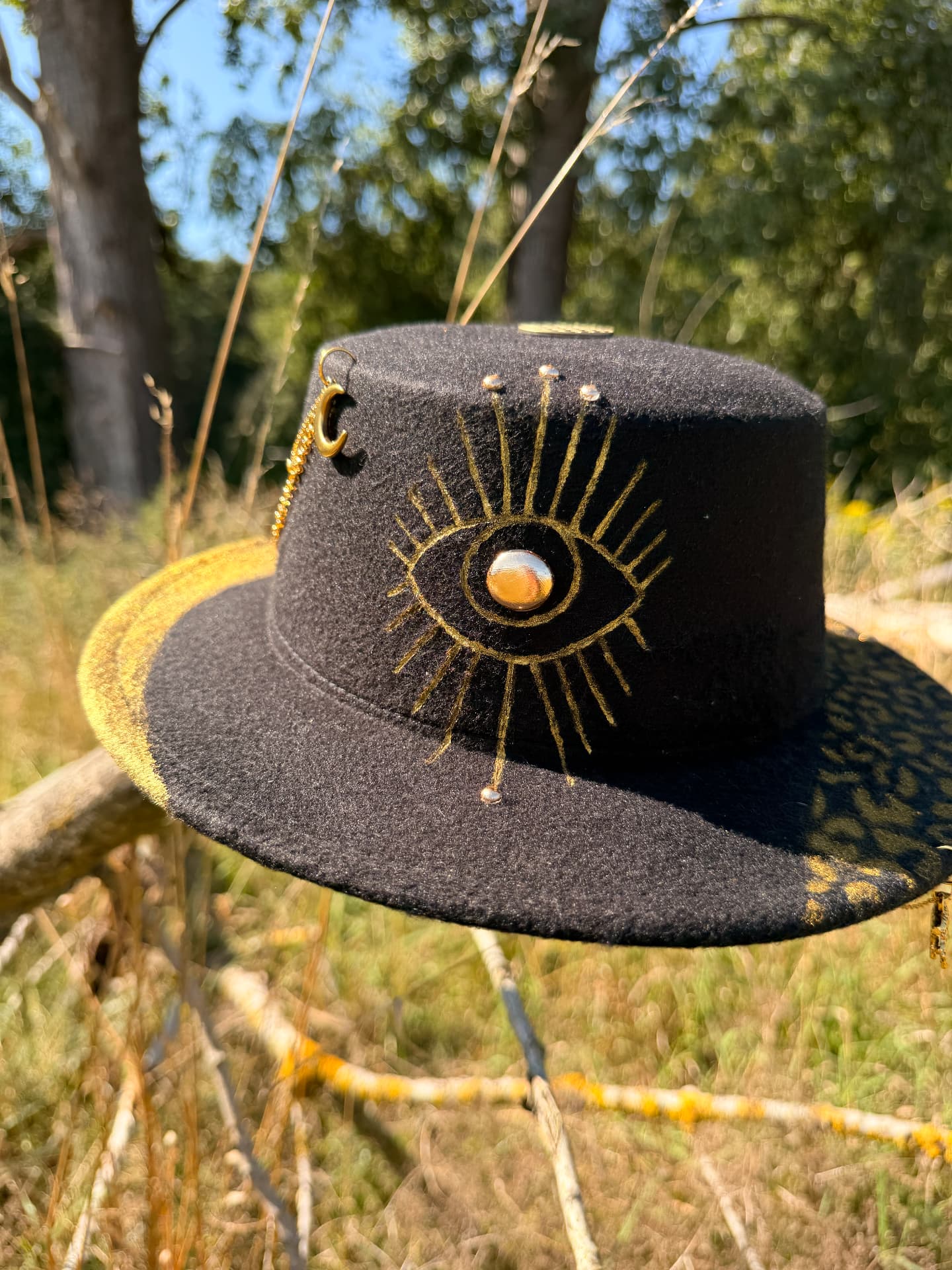 The Oracle, a black felt hat with a hand-painted golden eye and leopard brim